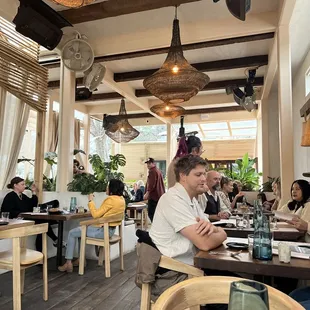 a group of people sitting at a table in a restaurant