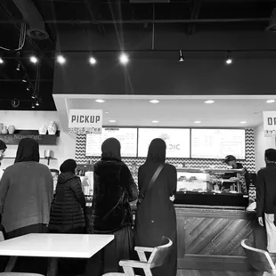 a black and white photo of diners