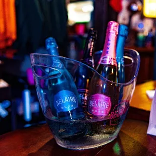 bottles of wine in a glass on a table
