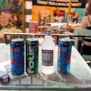 three cans of soda on a table