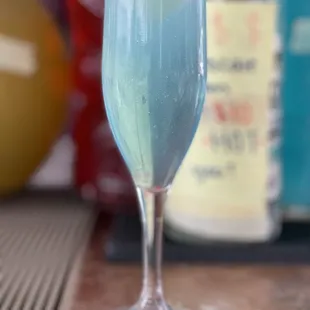 a blue drink in a wine glass