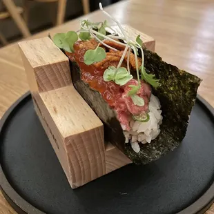 a sushi on a black plate