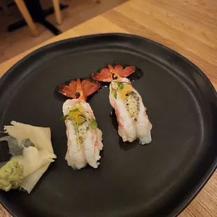 sushi on a black plate