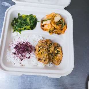 a styrofoam container of food