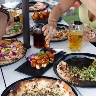 a group of people eating pizza
