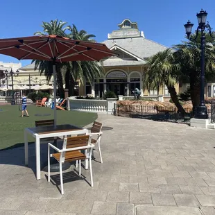 a patio with a table and chairs