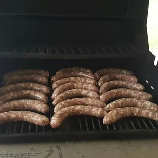 sausages cooking on a grill