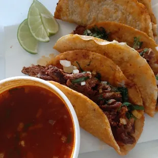 a plate of tacos and a bowl of salsa