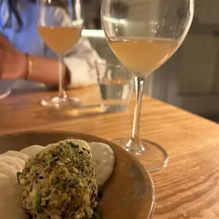 a plate of food and a glass of wine