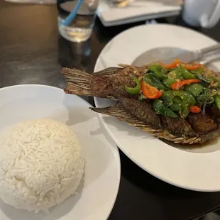 a plate of fish and rice
