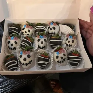 a box of decorated cupcakes