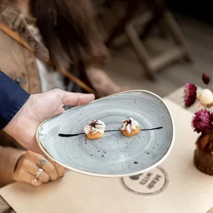 a person holding a plate of food
