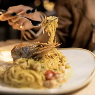 a plate of pasta and lobster