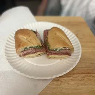 two sandwiches on a paper plate