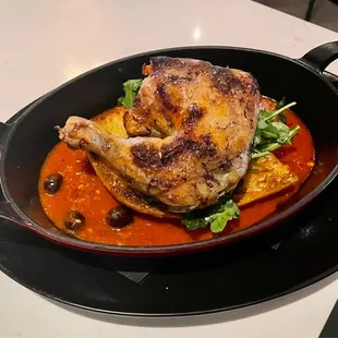 Pollo puttanesca: roasted half chicken, San Marzano sauce, kalamata olives, crispy focaccia