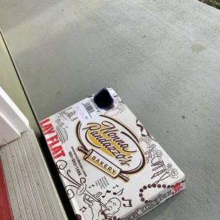 a pizza box on the ground