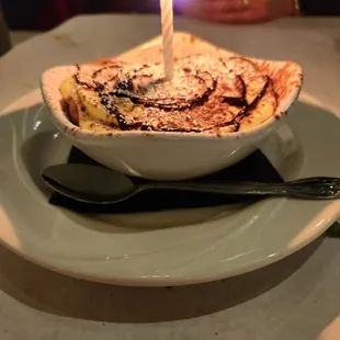 a pie with a lit candle