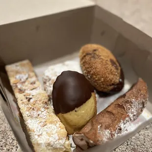 Madeline, chocolate cannoli, raspberry/almond bar, Nutella filled donut, cookie