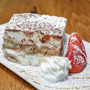 a piece of cake and a strawberry