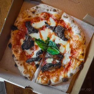 a pizza in a cardboard box