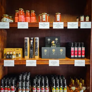 a shelf full of honeys and condiments