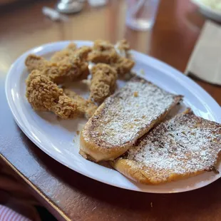 a plate of french toast and fried onion rings