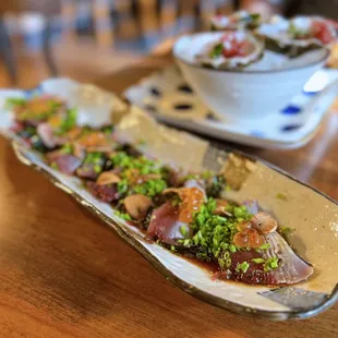 Bonito Tataki: Fresh seared bonito tuna, kaiso salad, wasabi ponzu, house garlic chips, bonito flake | HH-$7, Regular-$15