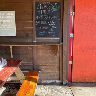 a bench and a chalk board