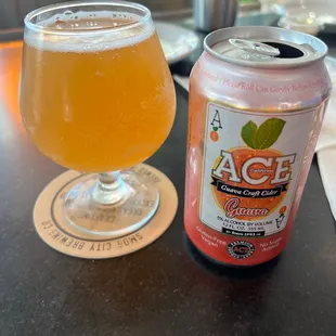 a can and a glass of beer on a table