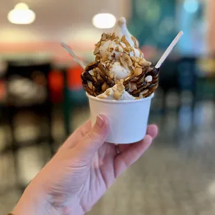 Peanut butter and marshmallow swirl with peanut butter sauce, peanuts, and a chocolate-covered pretzel
