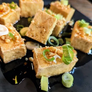 Loaded Fried Tofu. 8 pieces for $6. Fried tofu topped with peanuts, scallions, and sweet chili sauce.