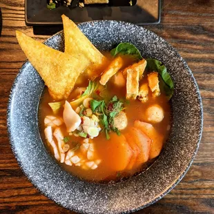 Yen Ta Fo. $17. Flat rice noodles with roasted pork, calamari, fish balls, fried tofu, and bok choy in a fermented soybean pink soup.