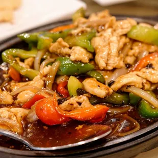 Chicken on sizzling hot plate in black bean sauce