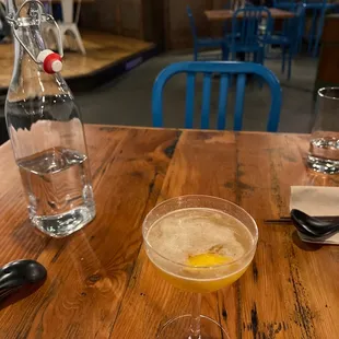 a drink in a glass on a wooden table