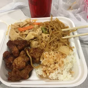 Lunch special with curry, noodles, rice and general tso chicken.