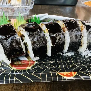 a sushi roll on a black plate