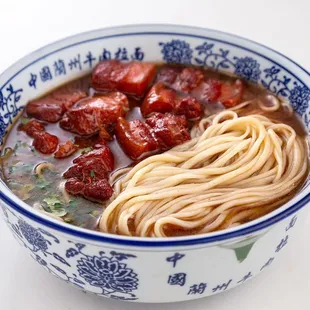 a bowl of soup with meat and noodles
