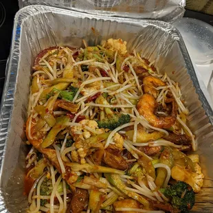 a pan of noodles and broccoli