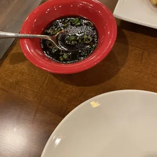 a bowl of soup with a spoon in it