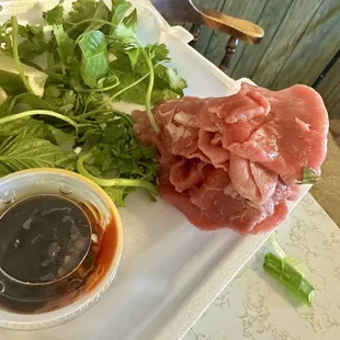 With tax. $22. Large beef pho two spring rolls two fried rolls. Sauce is perfect. Tons of meat. Tons of sprouts and herbs. Amazing.