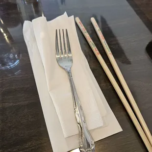 Utensils and chop sticks, napkins delivered in a white paper bag