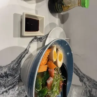 Spicy tuna roll, seafood ramen bowl.