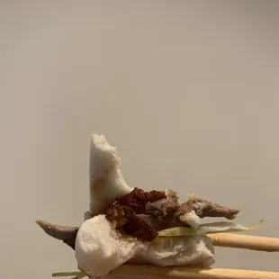 a piece of food on a chopstick