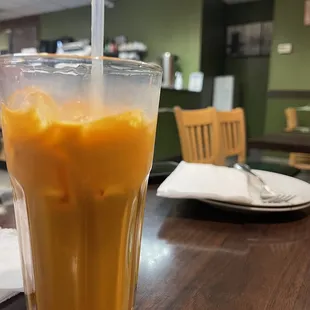 a glass of iced coffee on a table