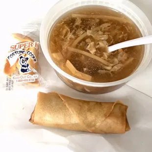 a bowl of soup and a roll