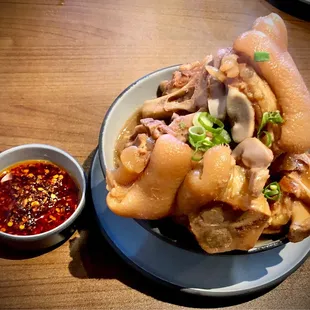 a plate of food with a bowl of sauce