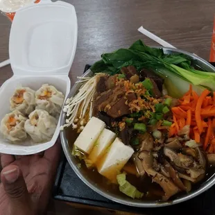 a person holding a bowl of food