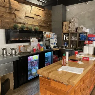 2021-09-25. Noodletopia, Madison Heights, MI. Drink station. They have a fireplace built into the wall.