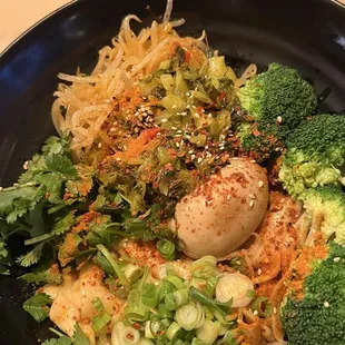 Garlic biang biang veggie noodle with pickled veggies and spiced egg.