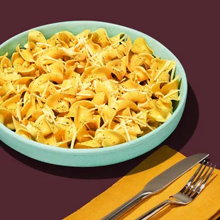 a bowl of noodles and a fork